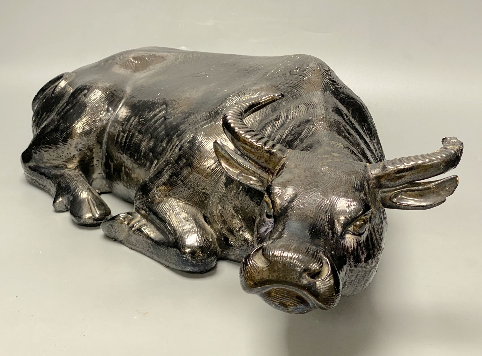 A Chinese pottery model of a recumbent buffalo, length 56cm